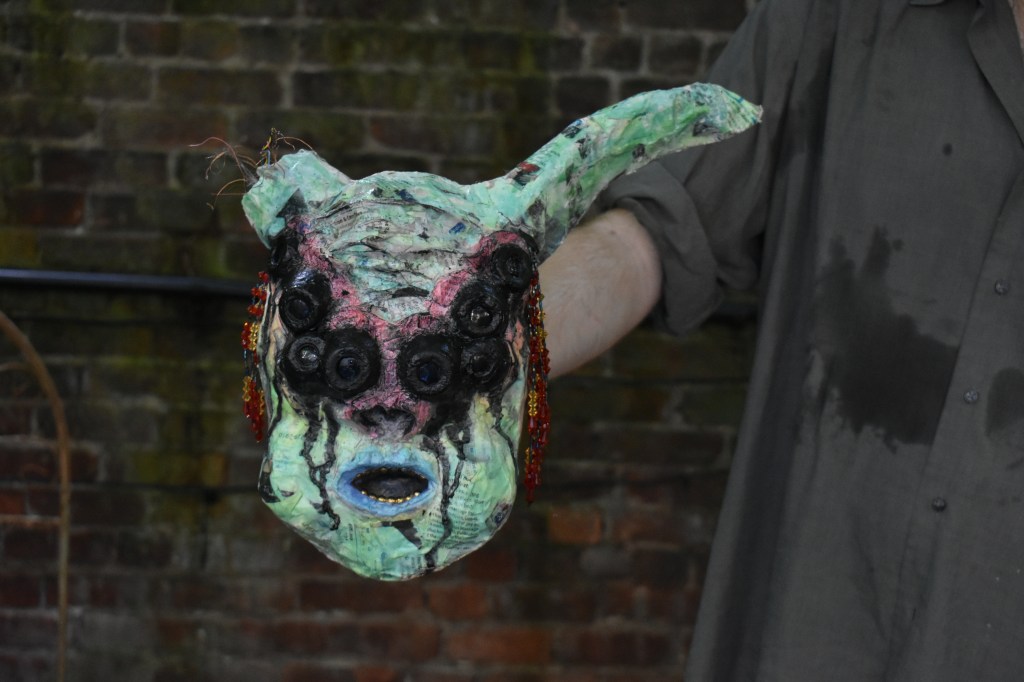 An Odd Mask--papier-mache, recycled plastic, watercolor, acrylic, found objects